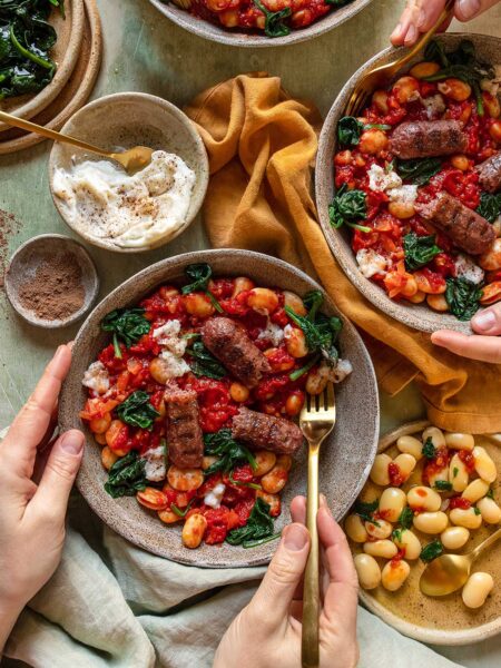 Teller mit Eintopf aus weißen Bohnen und Spinat, optional vegan mit Würstchen, verfeinert nach Rezept mit GO WILD FOOD FINISHER.