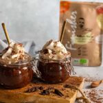 Ein cremiger Süßkartoffel-Schokopudding, angerichtet in einer Schale, garniert mit Schokoladenraspeln und frischen Beeren. Die samtige Textur und der natürliche Schokoladengeschmack machen dieses Dessert zu einer gesunden und leckeren Alternative.